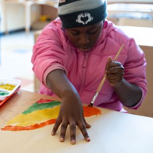Child painting at a table