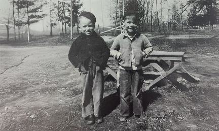 Two young boys wearing warm fall clothing smiling