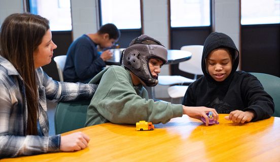 Children playing with toys on a wooden table
