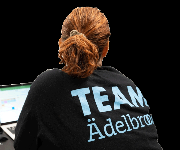 Adelbrook employee wearing a black t-shirt that says Team Adelbrook on the back