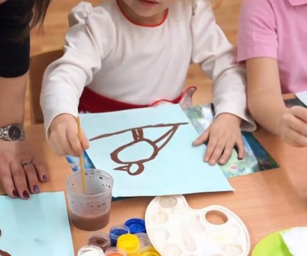 Young kid painting a bird