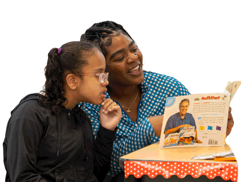 Woman reading a picture book to a young girl