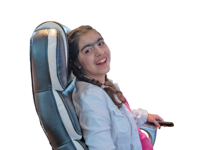 Young girl smiling while sitting in a chair