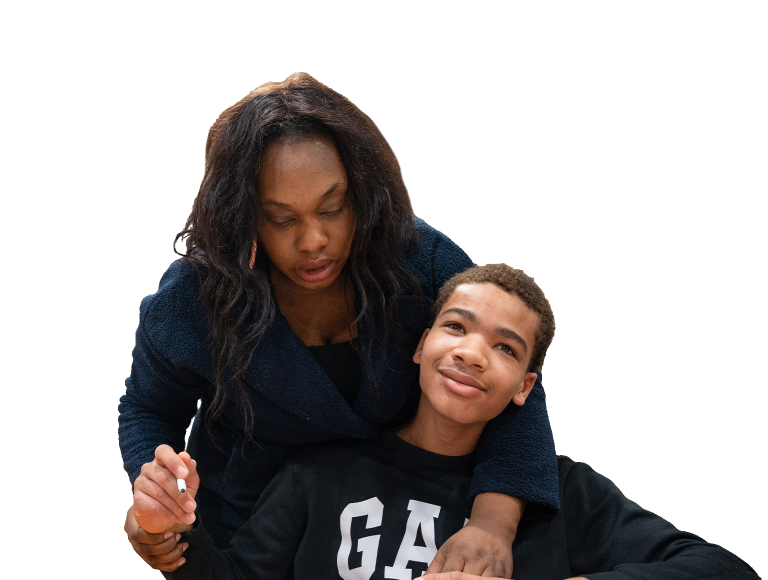Woman helping a young boy write