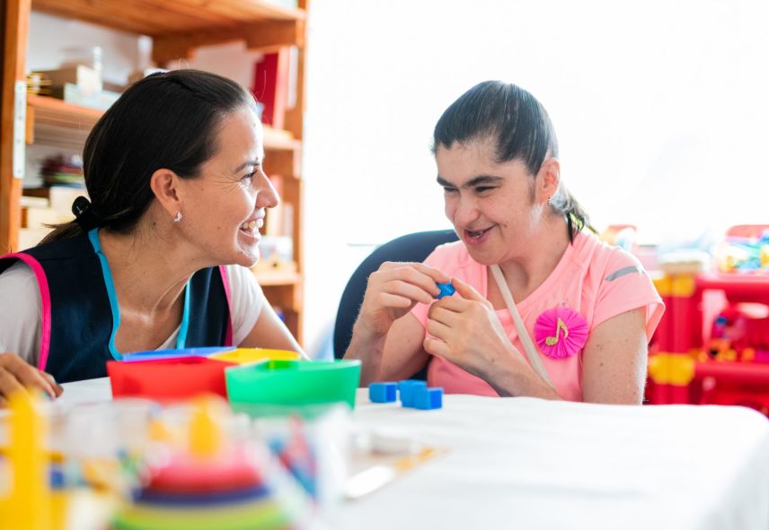 A woman and child play with blocks together