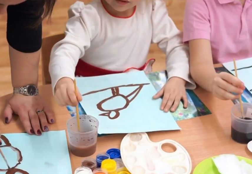 Young kid painting a bird