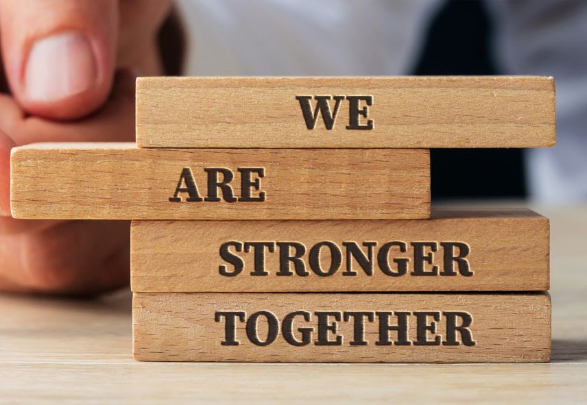 Stacked wooden blocks that say "We are stronger together"